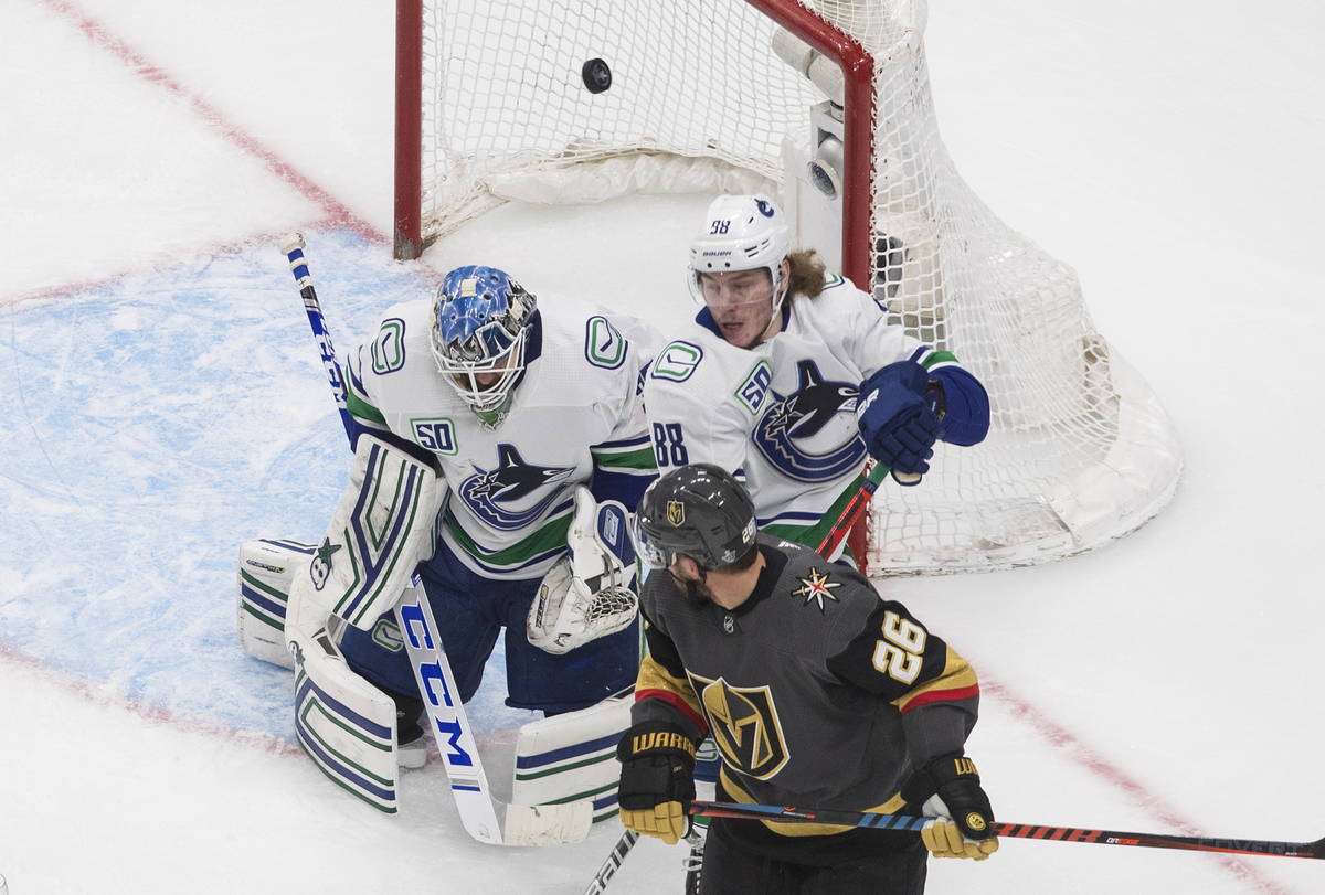 Vancouver Canucks goalie Thatcher Demko (35) makes a save as Vegas Golden Knights' Paul Stastny ...
