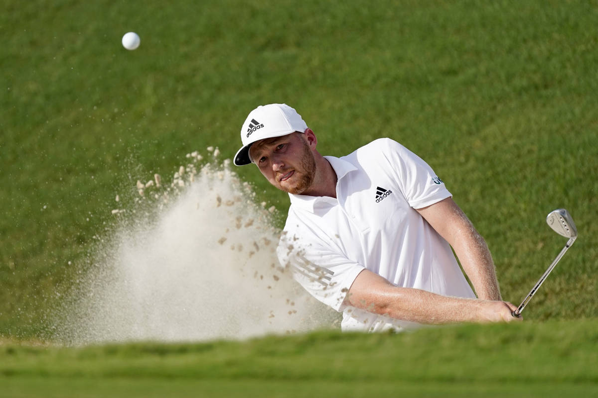 Daniel Berger hits from a greenside bunker on the 18th hole during the first round of play in t ...