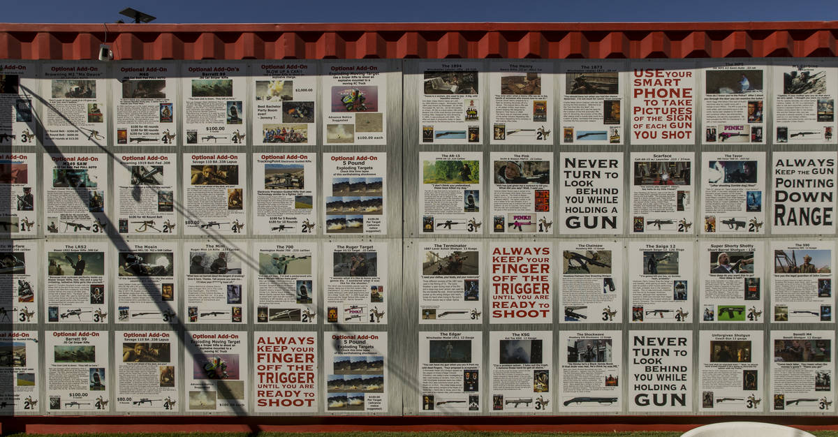 A wall at Adrenaline Mountain displays gun information and more about those available to shoot ...