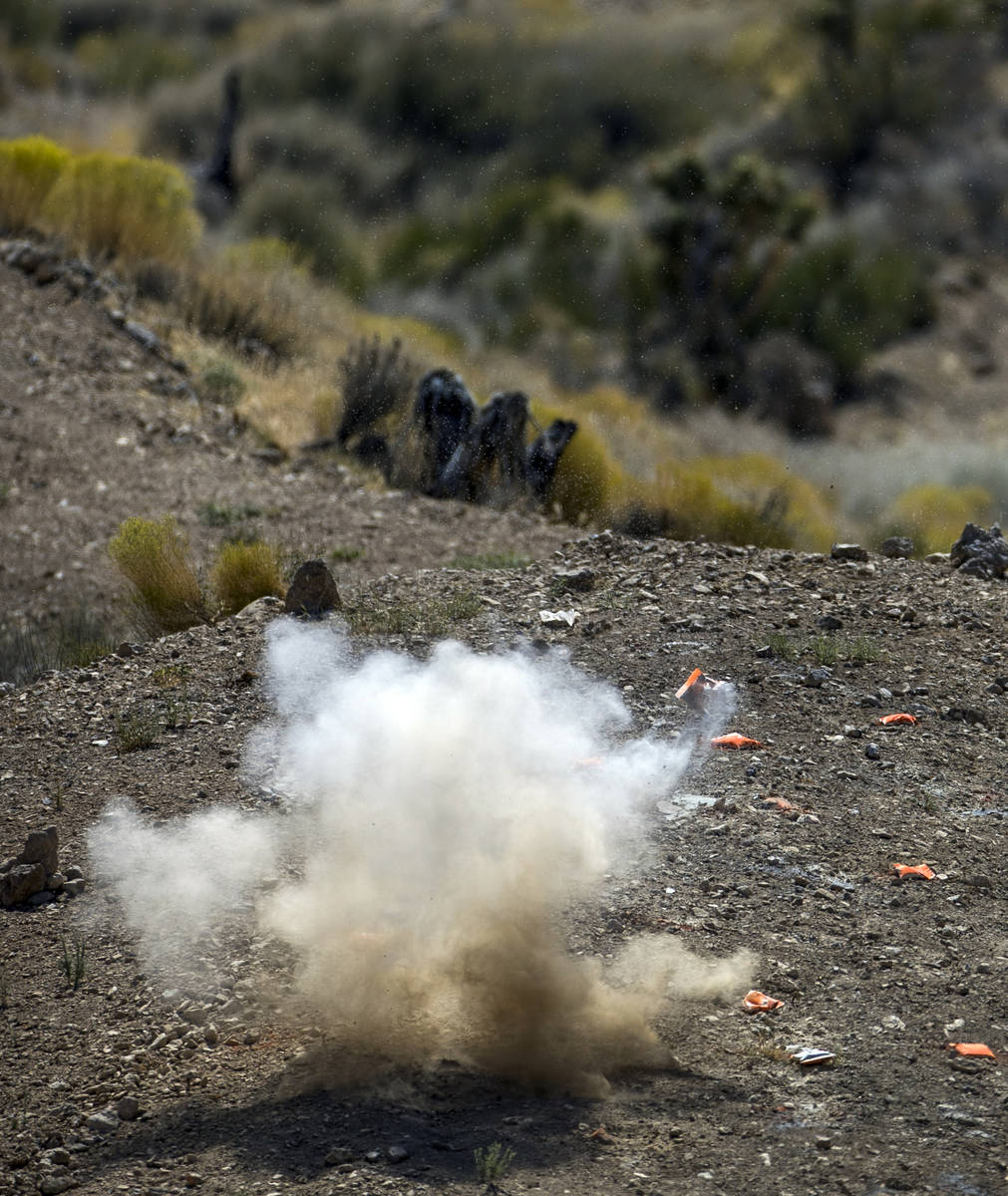 An explosive target blows up on the Adrenaline Mountain gun range, Thursday, Sept. 10, 2020, in ...