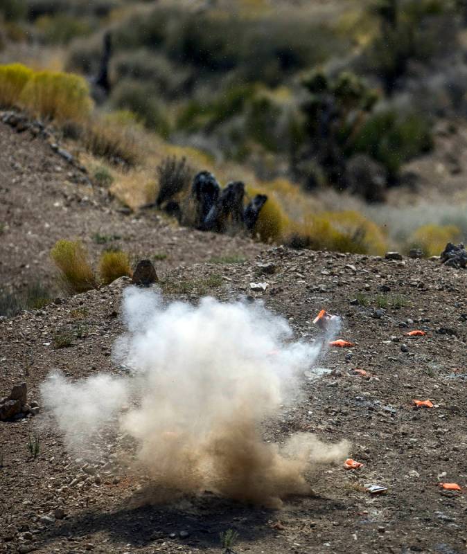 An explosive target blows up on the Adrenaline Mountain gun range, Thursday, Sept. 10, 2020, in ...