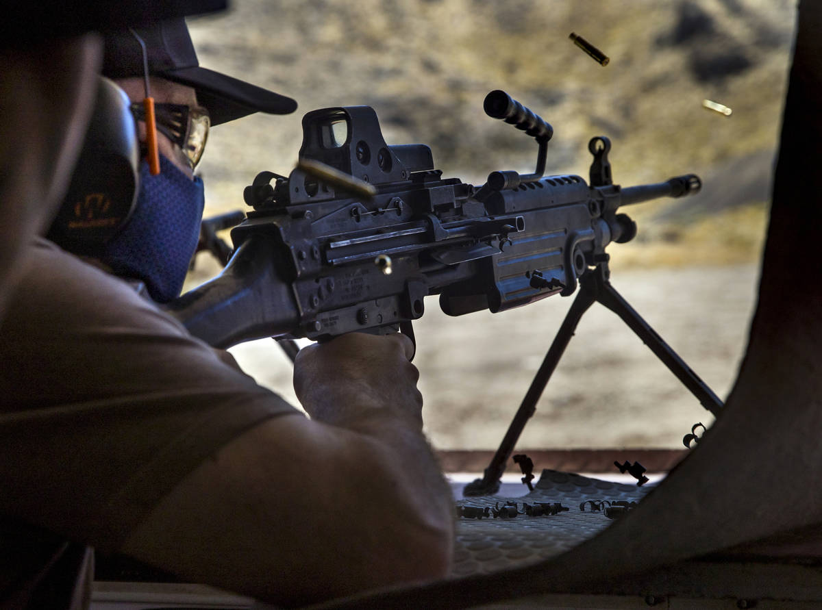 Christopher Lawrence fires an M249 Saw machine gun on the Adrenaline Mountain gun range, Thursd ...