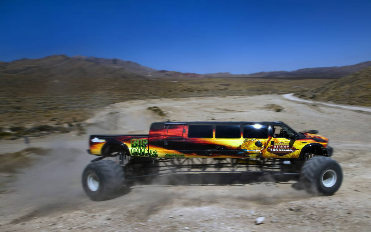 BIG GUNS, the world's longest monster truck, churns up some dirt while navigating a hill at Adr ...