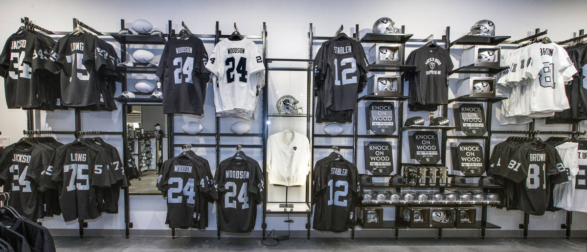 Classic player jerseys for sale flank an original Al Davis jacket within The Raider Image offic ...