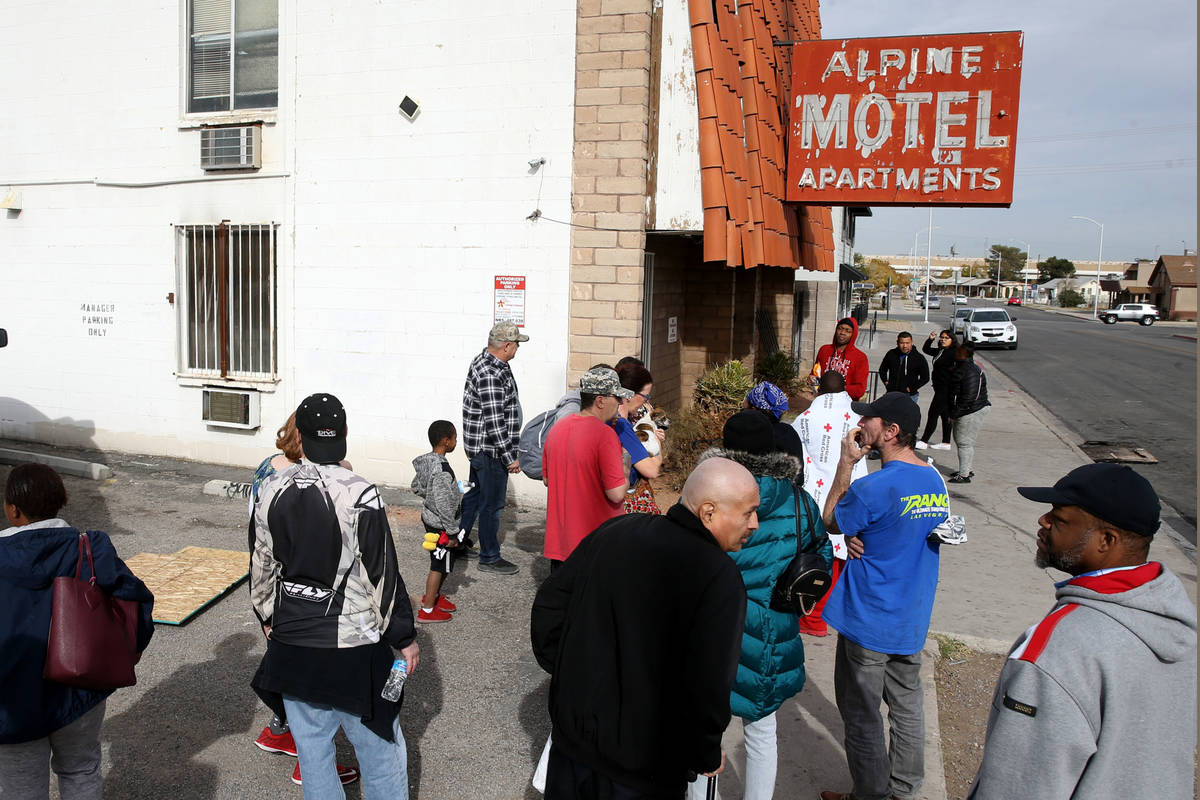 In this Dec. 21, 2019, file photo, residents gather at Alpine Motel Apartments after a fire lef ...