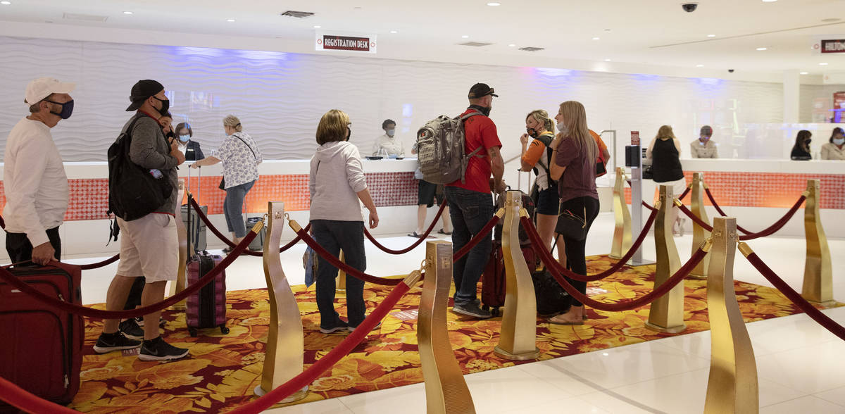 Gusts lined up to check in after the Tropicana hotel-casino reopens to public, on Thursday, Sep ...