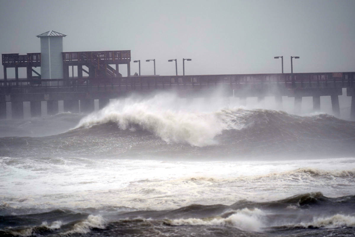 Waves crash near a pier, at Gulf State Park, Tuesday, Sept. 15, 2020, in Gulf Shores, Ala. Hurr ...