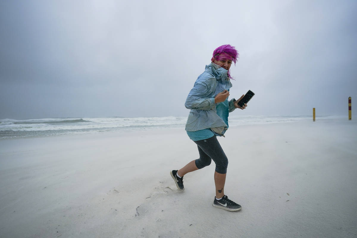 Courtney Watts, of Tuscaloosa, Ala., moves off the beach at Gulf State Park, Tuesday, Sept. 15, ...