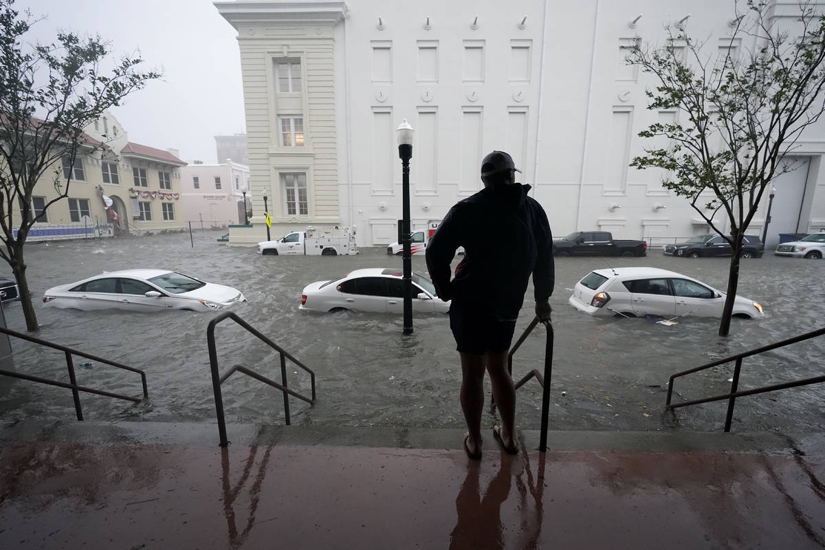 Flood waters move on the street, Wednesday, Sept. 16, 2020, in downtown Pensacola, Fla. Hurrica ...