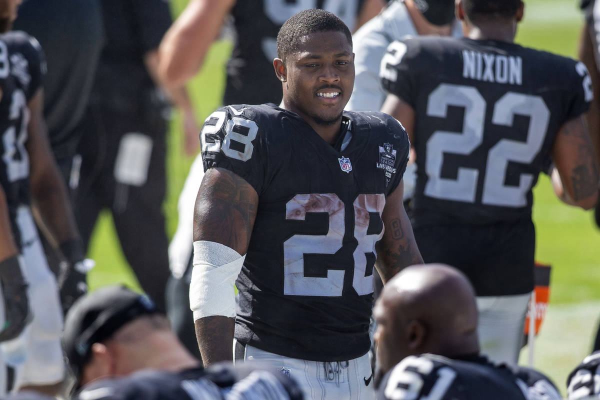 Las Vegas Raiders running back Josh Jacobs (28) smiles as he walks toward the bench in the 4th ...