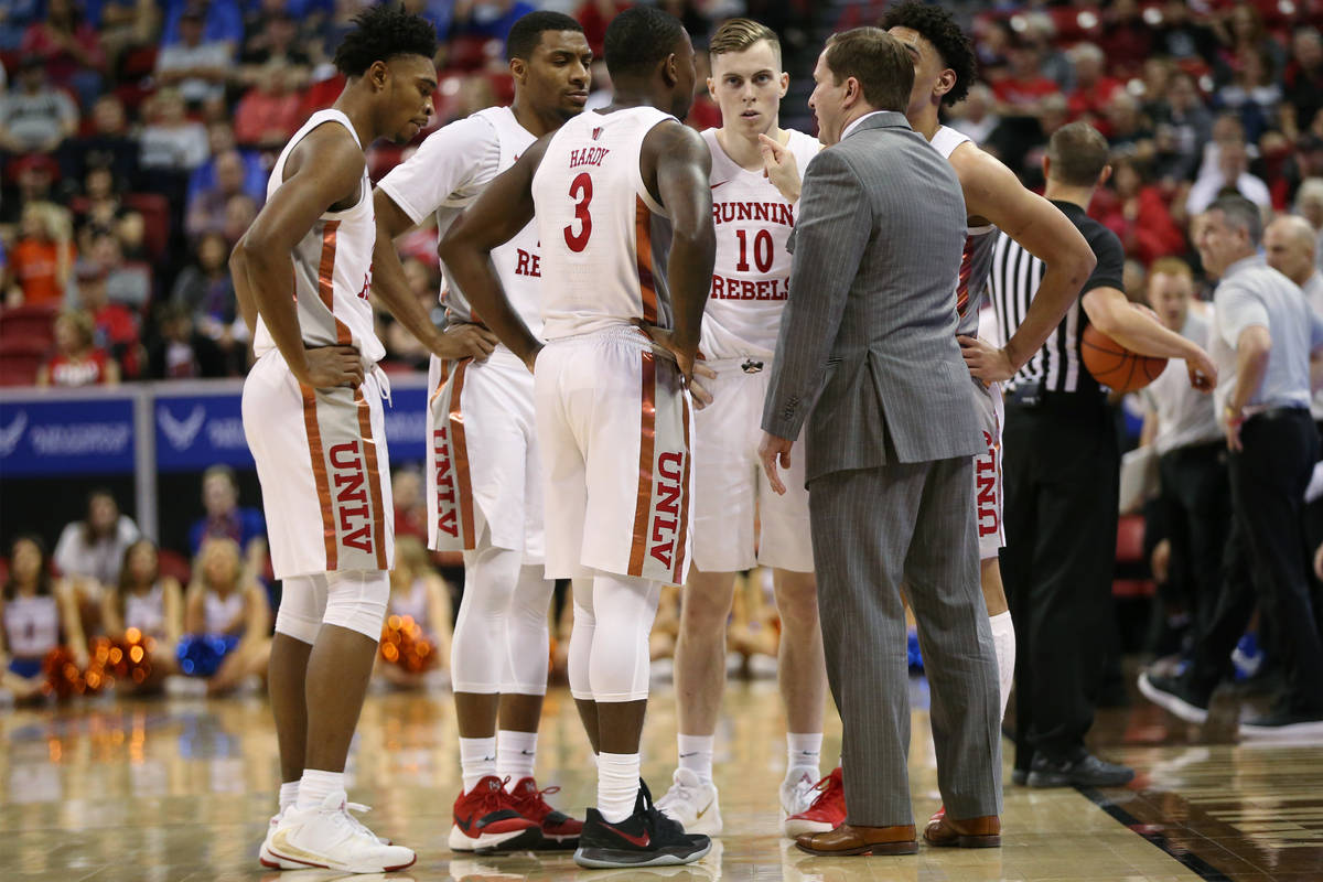 UNLV Rebels head coach T. J. Otzelberger talks to his team during a time out in the second half ...