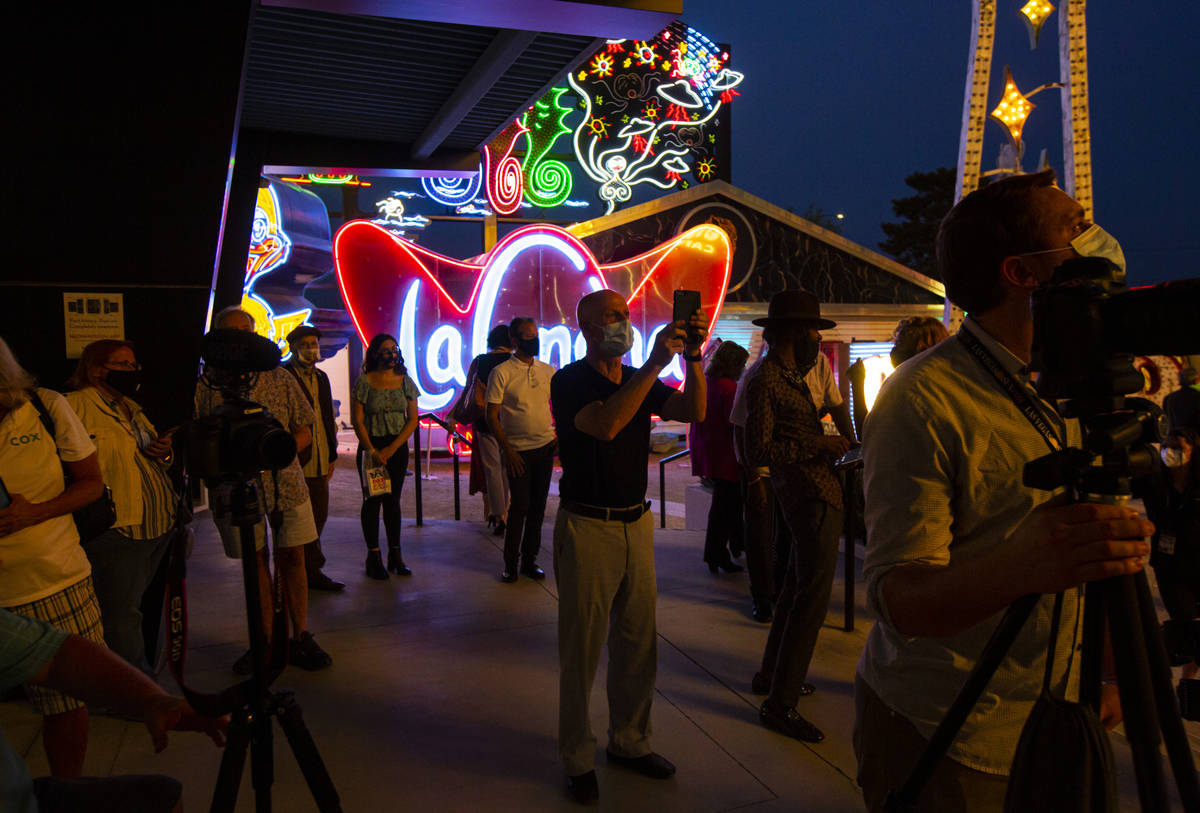 People take pictures before the reillumination of the Moulin Rouge sign at the Neon Museum in L ...