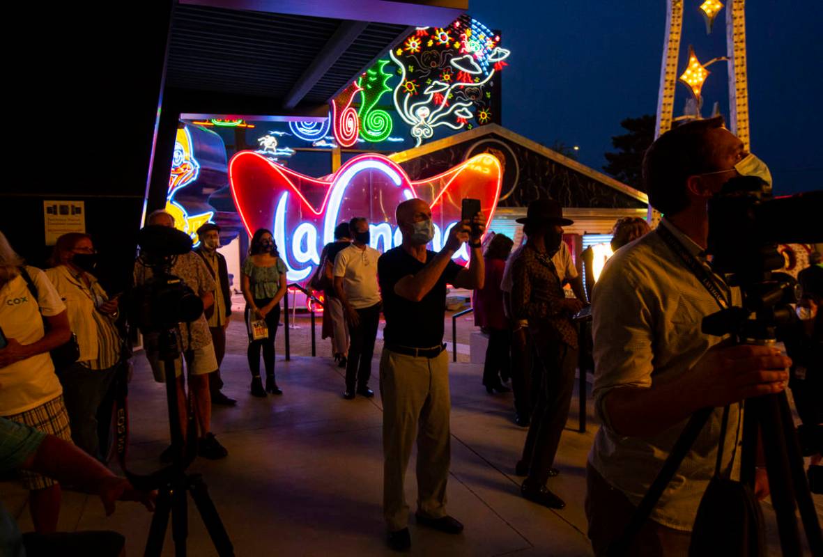 People take pictures before the reillumination of the Moulin Rouge sign at the Neon Museum in L ...