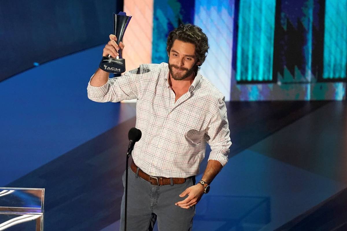 Thomas Rhett accepts the entertainer of the year award in a tie with Carrie Underwood during th ...