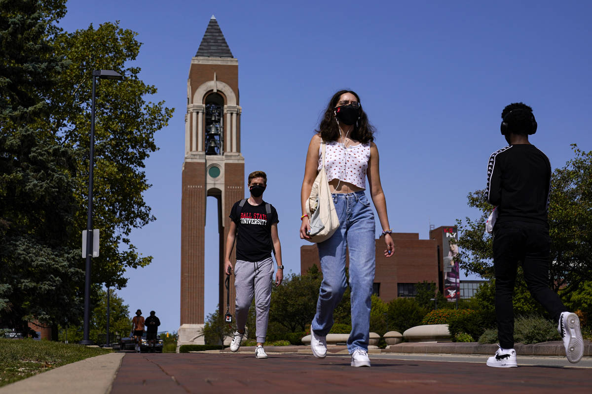 Masked students walk through the campus of Ball State University in Muncie, Ind., Thursday, Sep ...