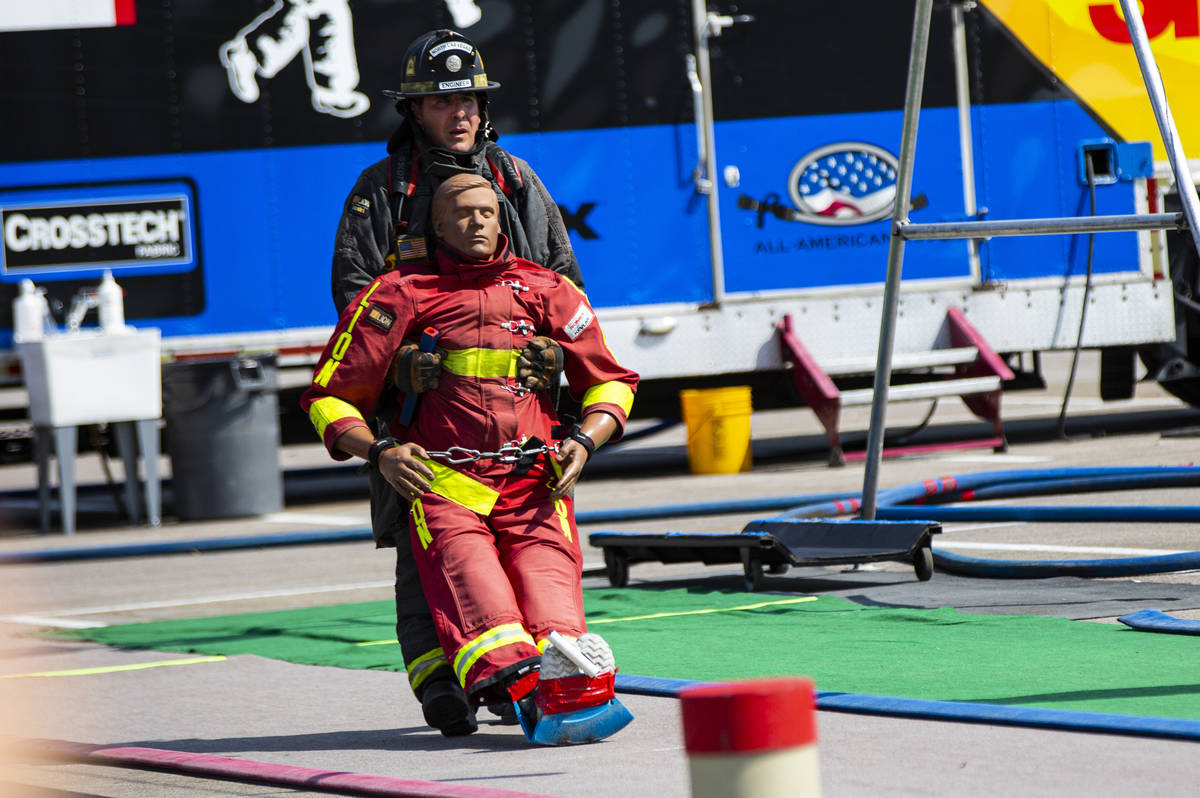 North Las Vegas fire engineer Matt Garcia rescues a dummy while competing in the Firefighter Co ...