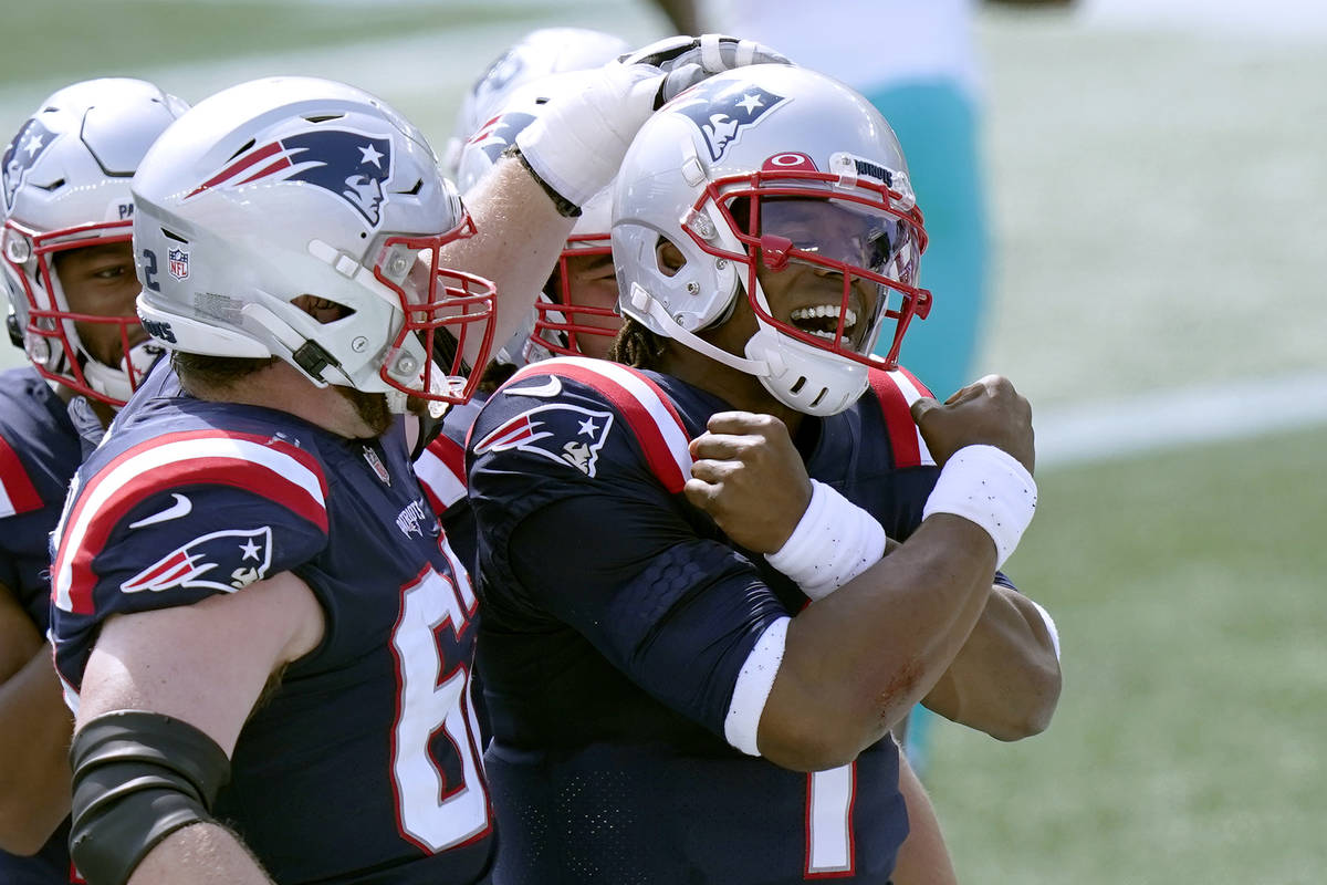 New England Patriots quarterback Cam Newton (1) celebrates his rushing touchdown against the Mi ...