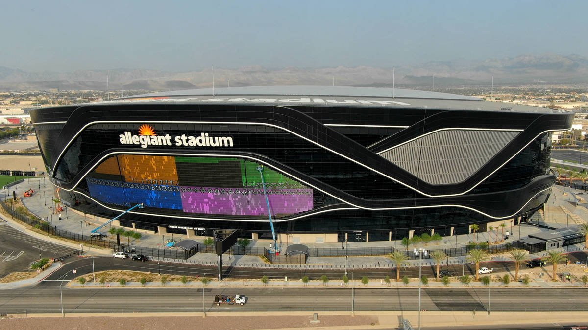 The massive 27,600-square-foot video board lights up with color on side of Allegiant Stadium th ...