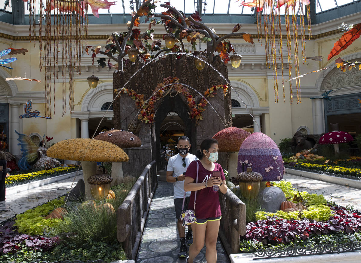 Tourists visit the new fall display called "Into the Woods" at the Bellagio Conservatory on Tue ...