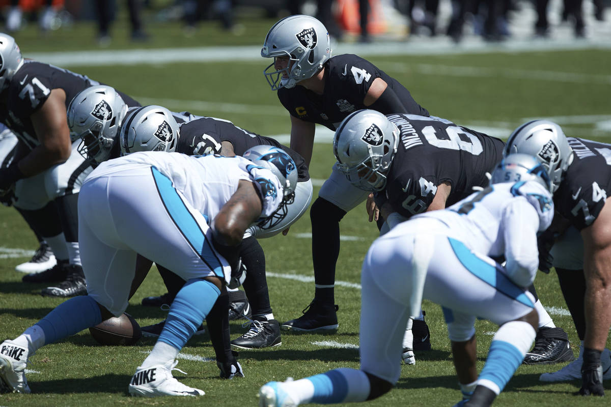 Las Vegas Raiders quarterback Derek Carr (4) lines up under center during the first half of an ...