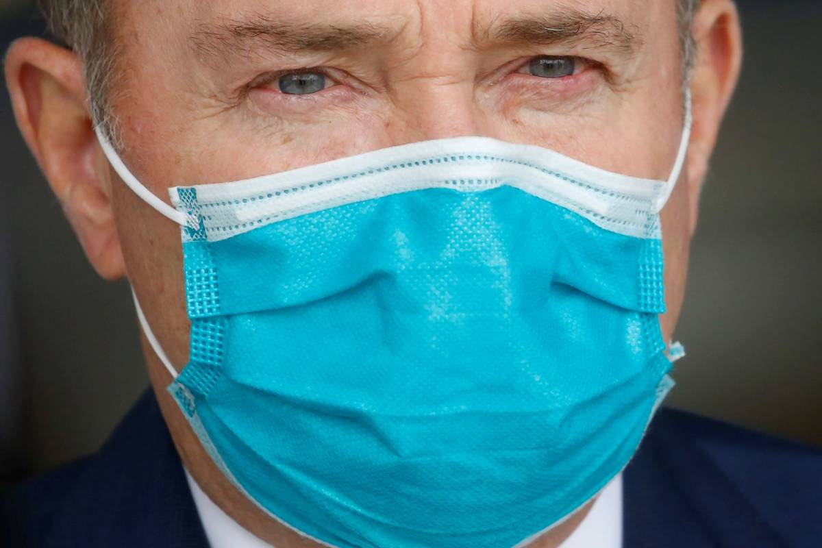 Utah Gov. Gary Herbert wears a mask during a news conference on April 15, 2020, in Salt Lake Ci ...