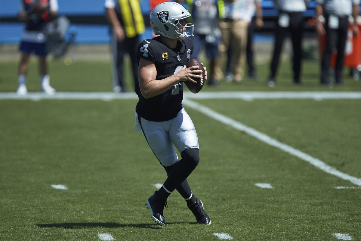 Las Vegas Raiders quarterback Derek Carr (4) drops back to pass during an NFL football game aga ...