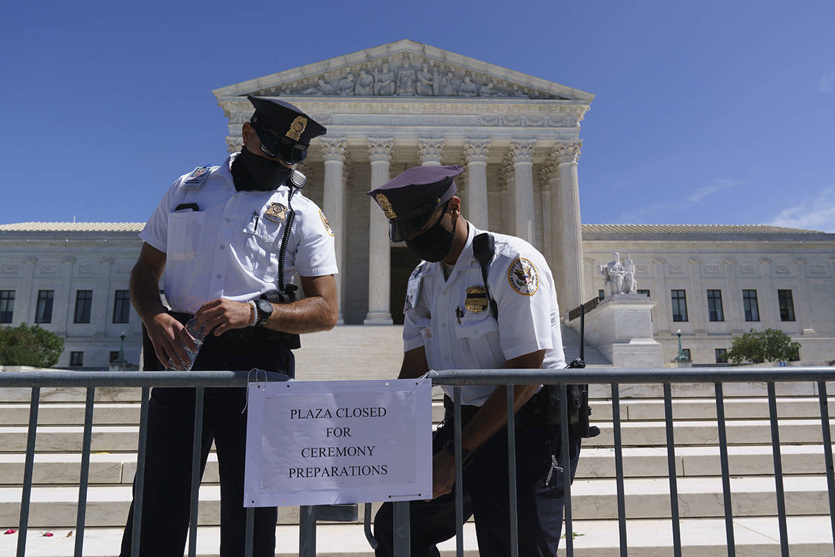 Police officers at the Supreme Court close the plaza on the day after the death of Justice Ruth ...