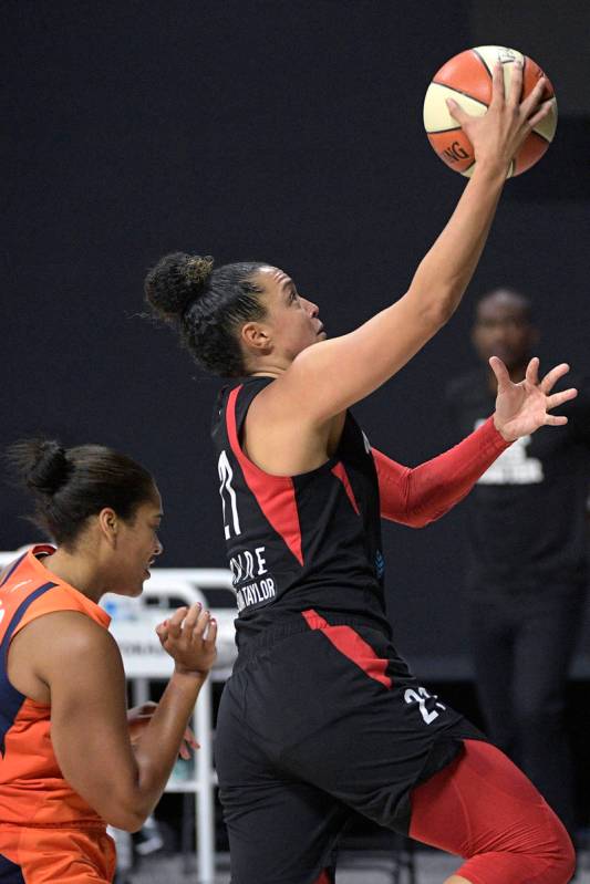 Las Vegas Aces guard Kayla McBride (21) goes up to shoot in front of Connecticut Sun center Bri ...