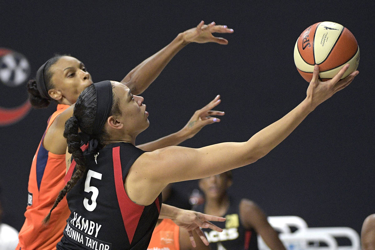 Las Vegas Aces forward Dearica Hamby (5) goes up to shoot in front of Connecticut Sun forward D ...