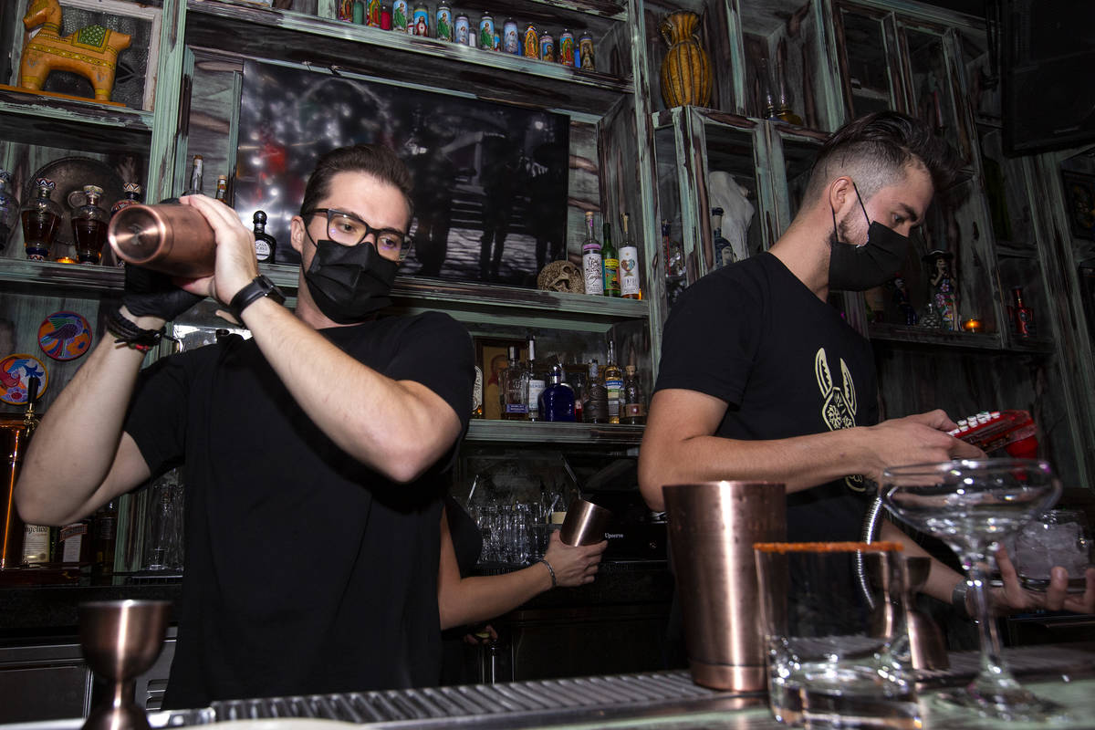 Bartender Chance Bennett, left, shakes a cocktail at Lucky Day Tequila & Mezcal House on th ...
