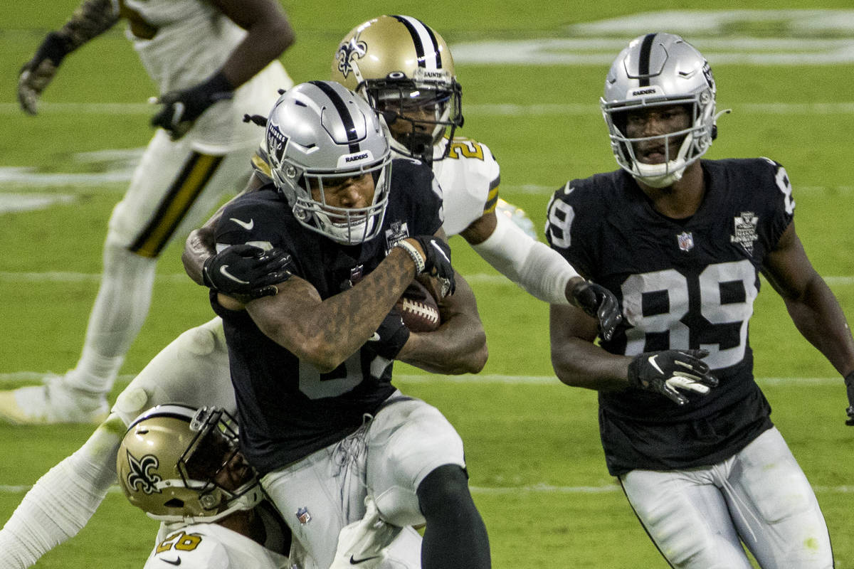 Las Vegas Raiders tight end Darren Waller (83) battles through a tackle attempt by New Orleans ...