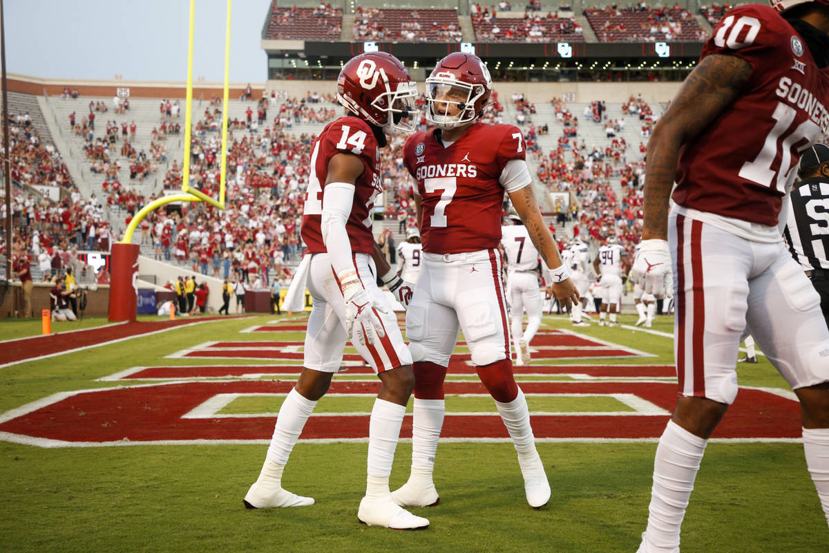 Oklahoma wide receiver Charleston Rambo (14) and quarterback Spencer Rattler (7) celebrate afte ...