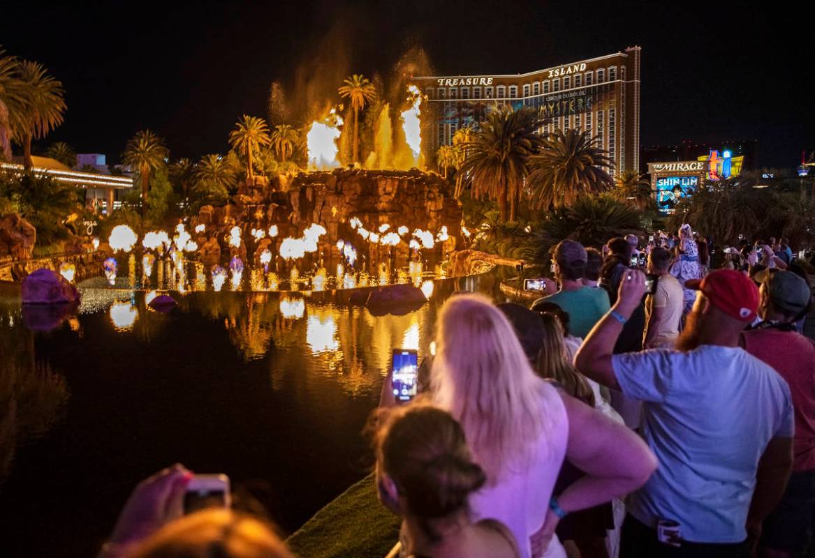 People on the Strip watch the first volcano show since the opening of the The Mirage earlier in ...