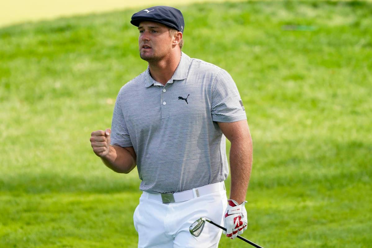 Bryson DeChambeau, of the United States, reacts after playing a shot on the fourth hole during ...