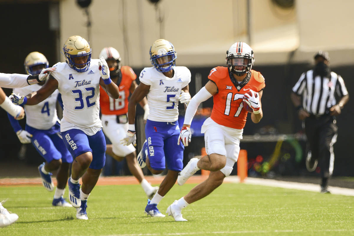 Oklahoma State wide receiver Dillon Stoner (17) runs the ball against Tulsa during an NCAA coll ...