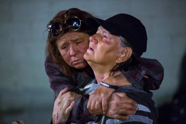 Alice Pate, left, comforts Kathleen Sutton as she talks about the struggles of living on the st ...
