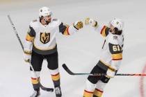 Vegas Golden Knights' Shea Theodore, left, celebrates his goal against the Dallas Stars with Ma ...