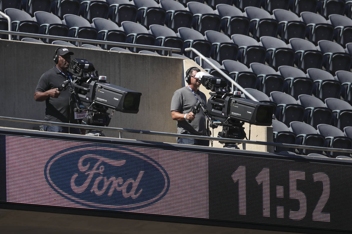 A TV camera crew is seen during the first half of an NFL football game between the Chicago Bear ...