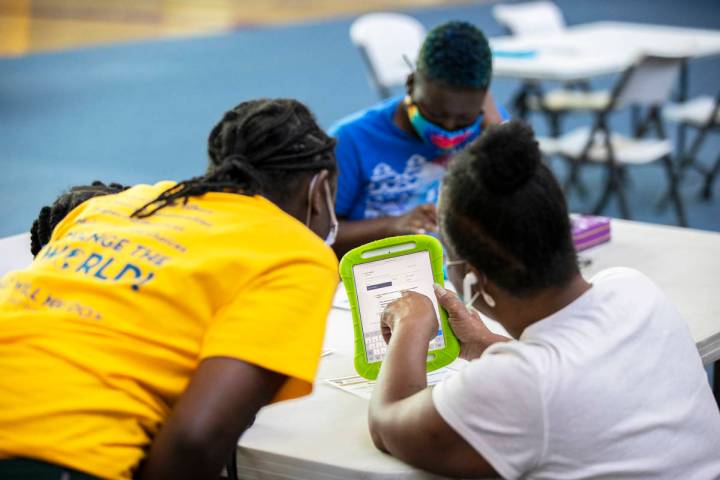 Debra Foster, bottom/right, asks for assistance in registering to vote during a vote drive as p ...