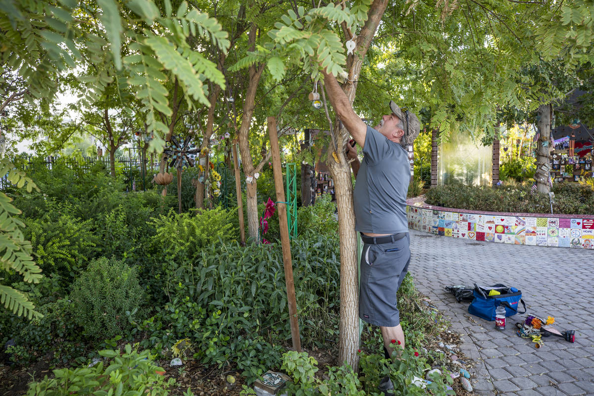 Eddie Schmitz, a volunteer that restores and upkeeps the Las Vegas Healing Garden, carefully ta ...