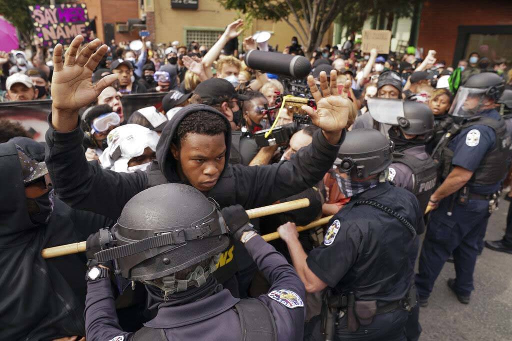 Police and protesters converge during a demonstration, Wednesday, Sept. 23, 2020, in Louisville ...