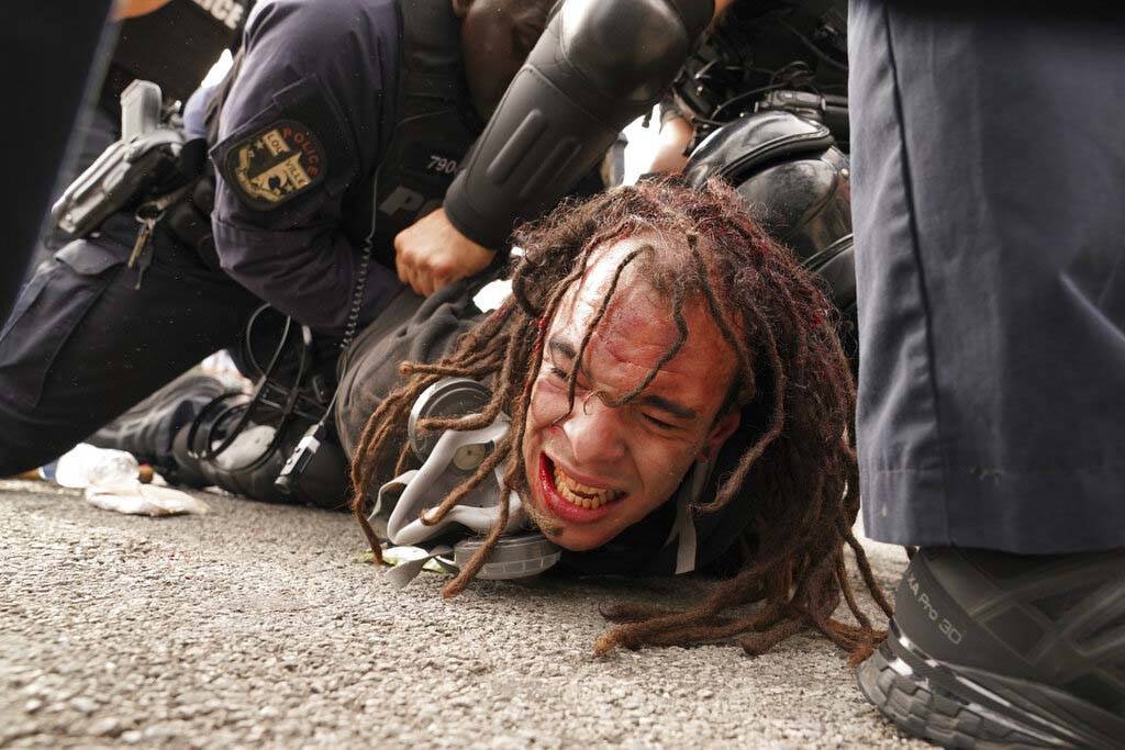 Louisville police detain a man after a group marched, Wednesday, Sept. 23, 2020, in Louisville, ...