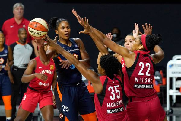 Connecticut Sun forward Alyssa Thomas (25) pass the ball as she is guarded by Las Vegas Aces fo ...