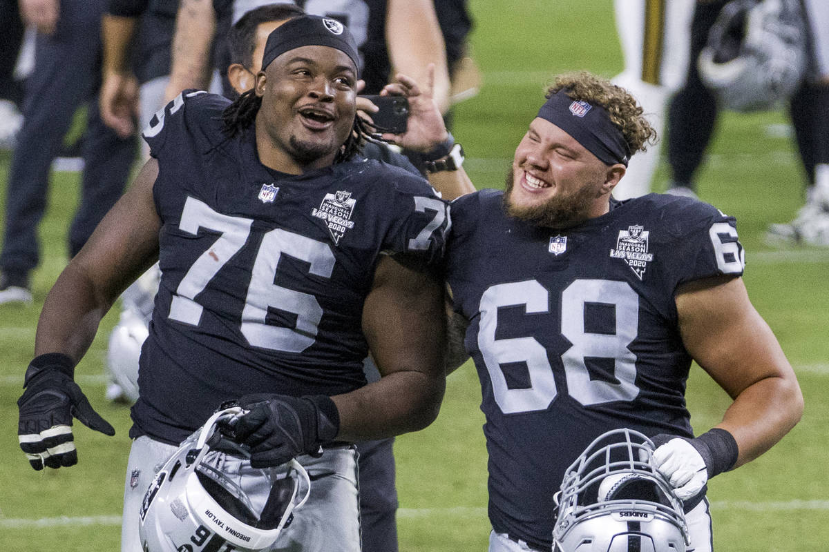 Las Vegas Raiders offensive guard John Simpson (76, left) and offensive tackle Andre James (68) ...