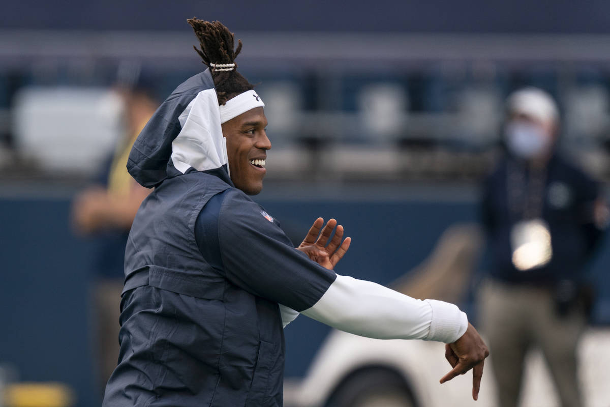 New England Patriots quarterback Cam Newton warms up before an NFL football game against the Se ...