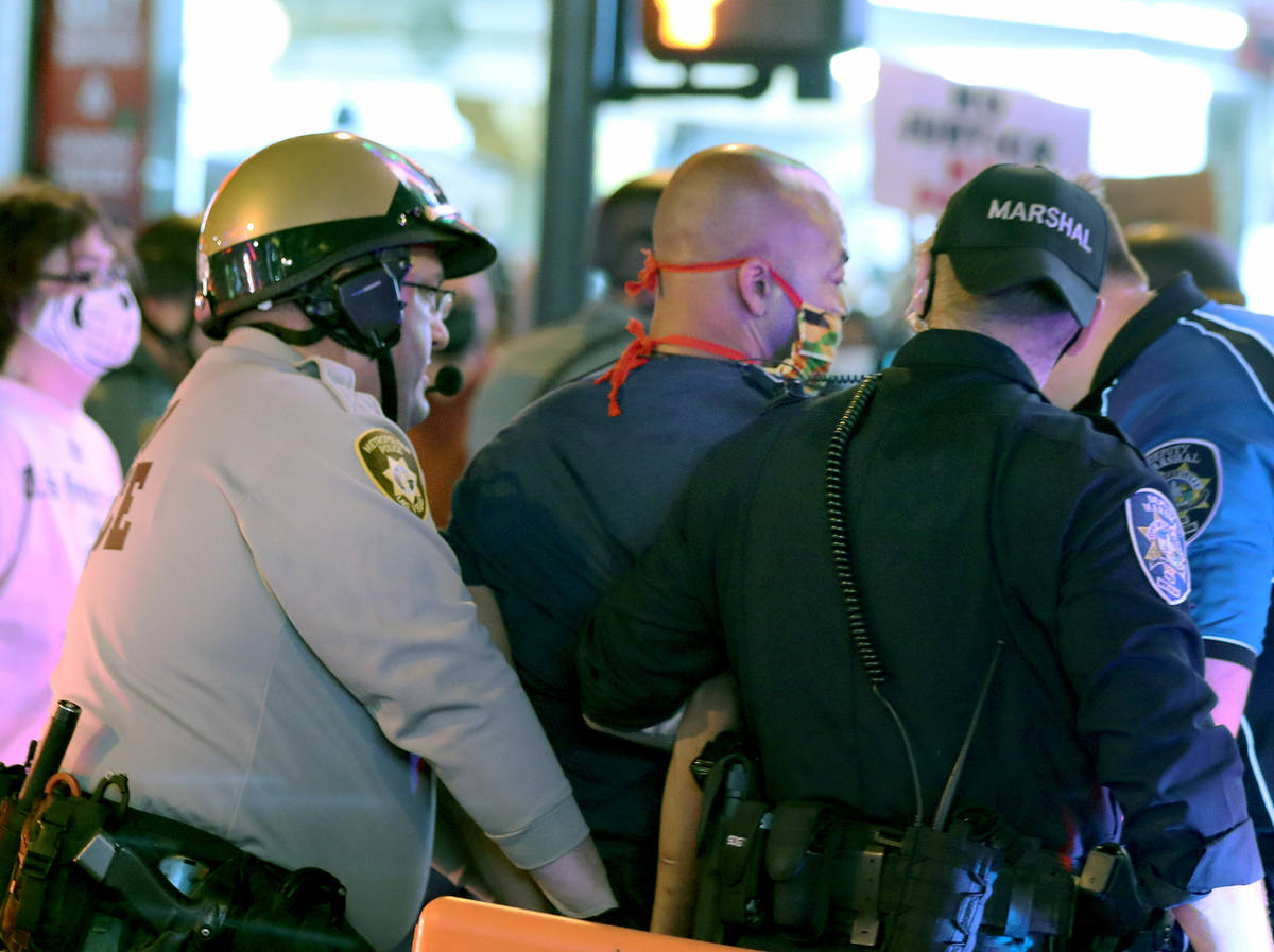 Las Vegas defense attorney Jonathan MacArthur is arrested during a demonstration in honor of Br ...