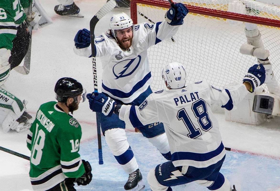 Tampa Bay Lightning center Brayden Point (21) celebrates his goal with Ondrej Palat, right, as ...