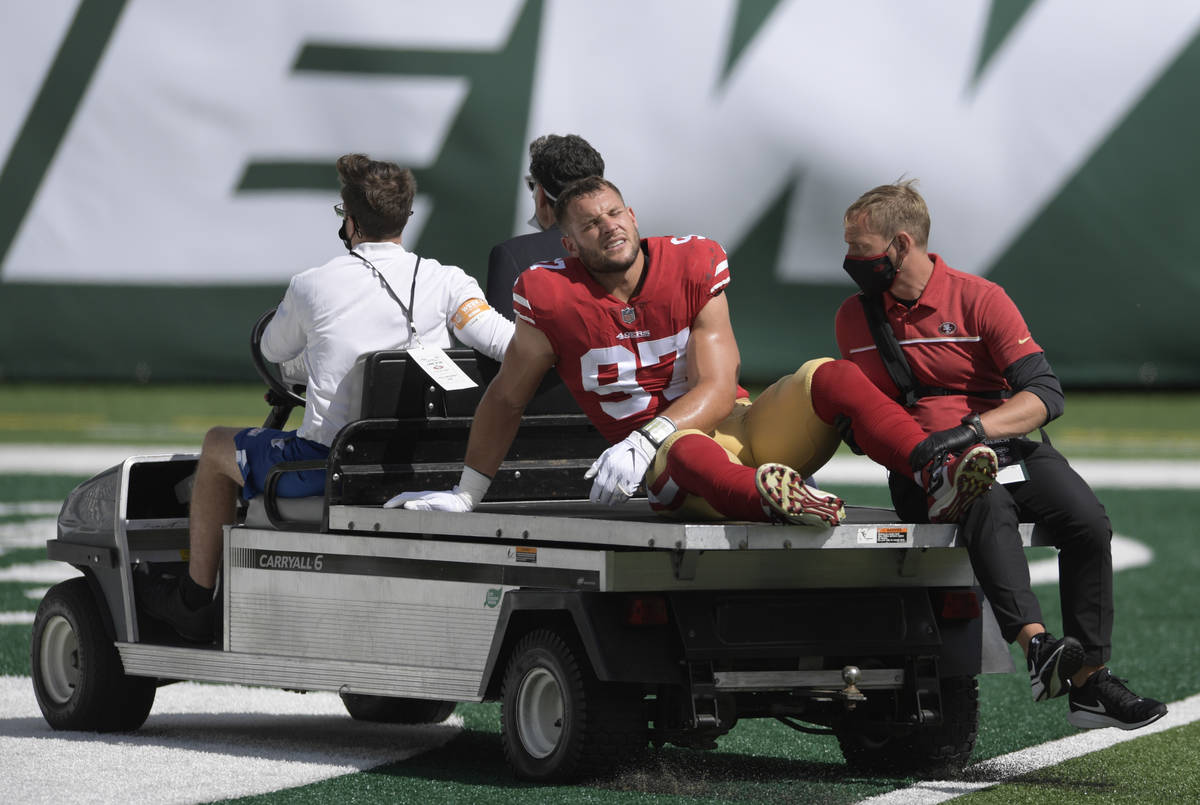 San Francisco 49ers defensive end Nick Bosa (97) is driven off the field after being injured du ...