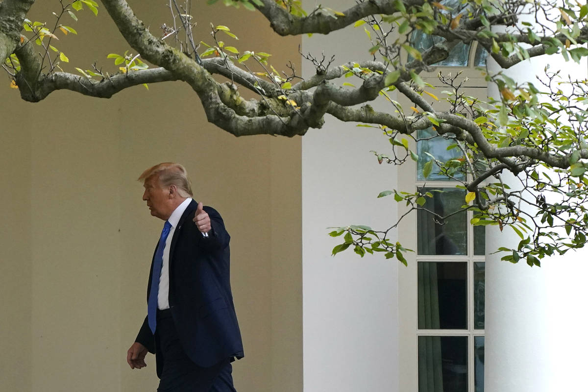 President Donald Trump gestures to members of the press as he walks to the Oval Office of the W ...