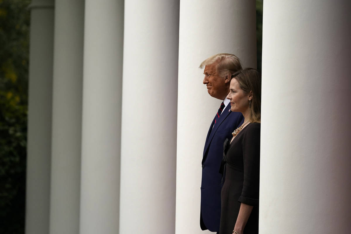President Donald Trump walks with Judge Amy Coney Barrett to a news conference to announce Barr ...